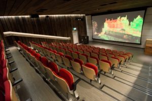 The Engine Shed auditorium with rows of red chairs and a point cloud on screen