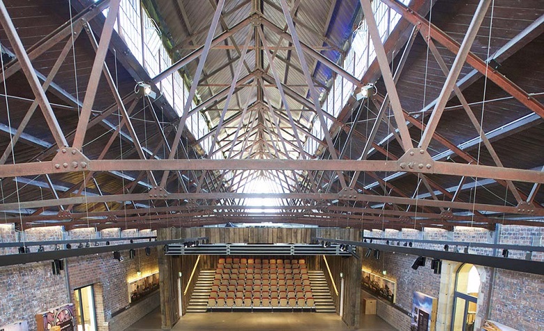 The Engine Shed, Stirling, an interior shot showing metal roof structure and a large map of Scotland