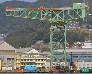 The green Nagaski Crane, surrounded by industrial buildings
