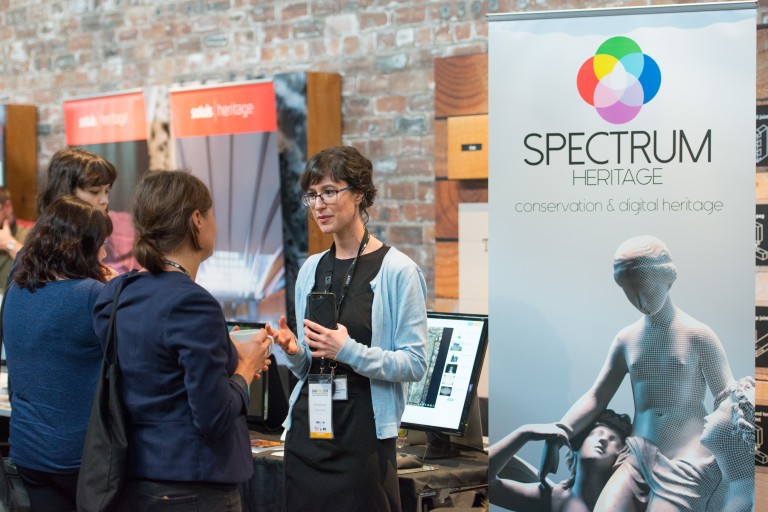 People talking inside the Engine Shed beside a Spectrum Heritage banner