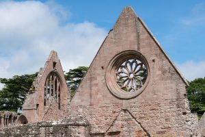 A circular window with a floral design at Dryburgh Abbey