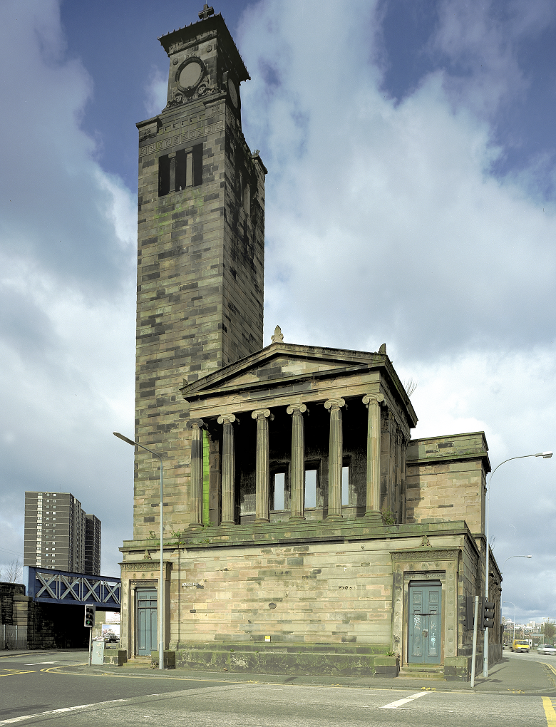 A large, stone church on a stone plinth, featuring columns