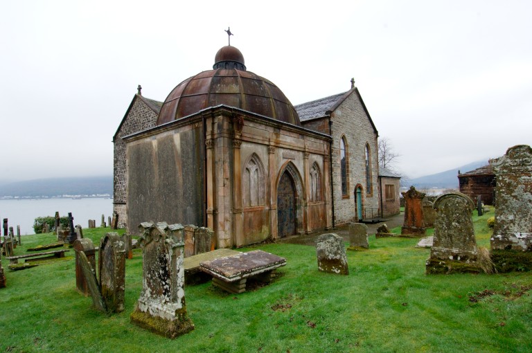 A mausileum in a graveyard