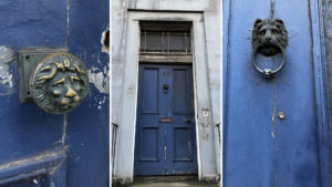 A blue tenement door, a lion door handle and a lion door knocker