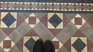 A square and diamond patterned tile floor