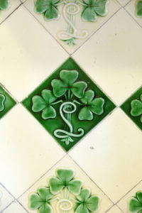 Green and white wall tiles, decorated with clovers