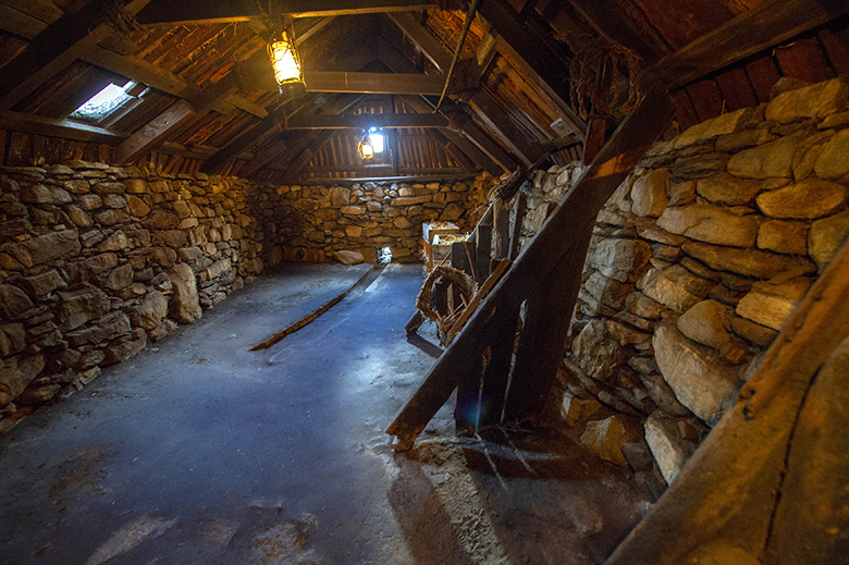 Inside Arnol Blackhouse, which has walls built from stone held together with earth mortar 