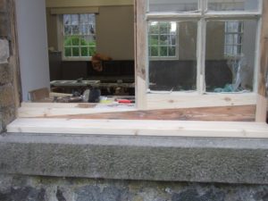 A sash and case window cill being repaired in the frame