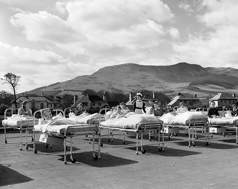Hospital beds outside on the grass