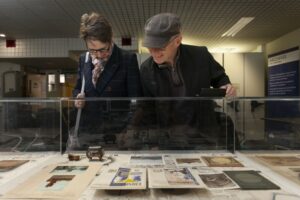 Two people looking at archive images in a cabinet