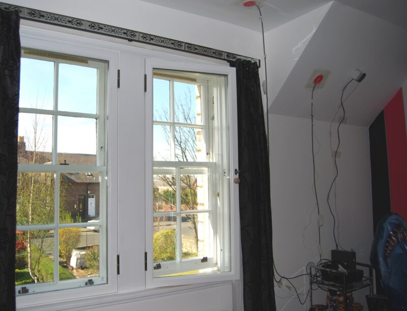 Two sash and case windows which hae a secondary window fitted over them on the inside