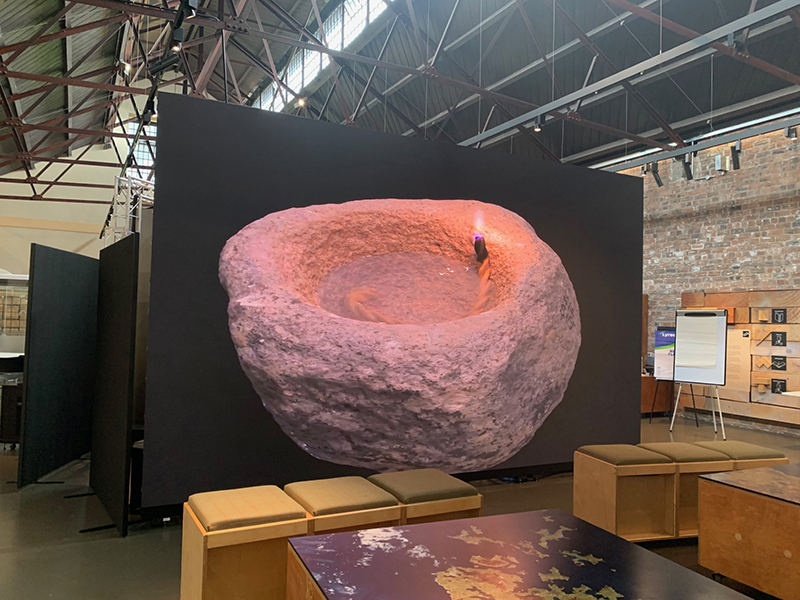 A large, free standing LED screen inside the Engine Shed. A 3D model of an iron age lamp from the Broch of Gurness in Orkney is displayed on the screen.