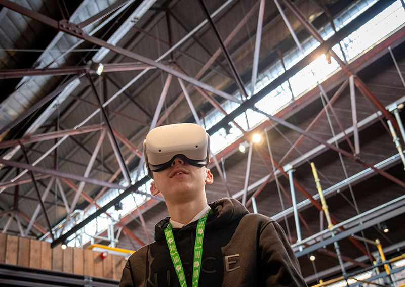 A young person wearing a VR headset inside the Engine Shed
