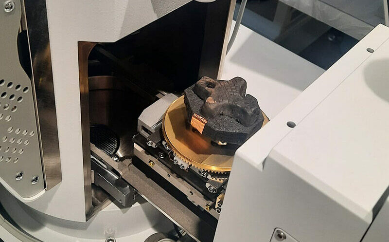 A tiny cross placed inside a piece of scientific equipment