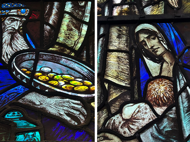 A stained glass window of an old, bearded man holding a container of gold coins, and a hooded woman holding a baby