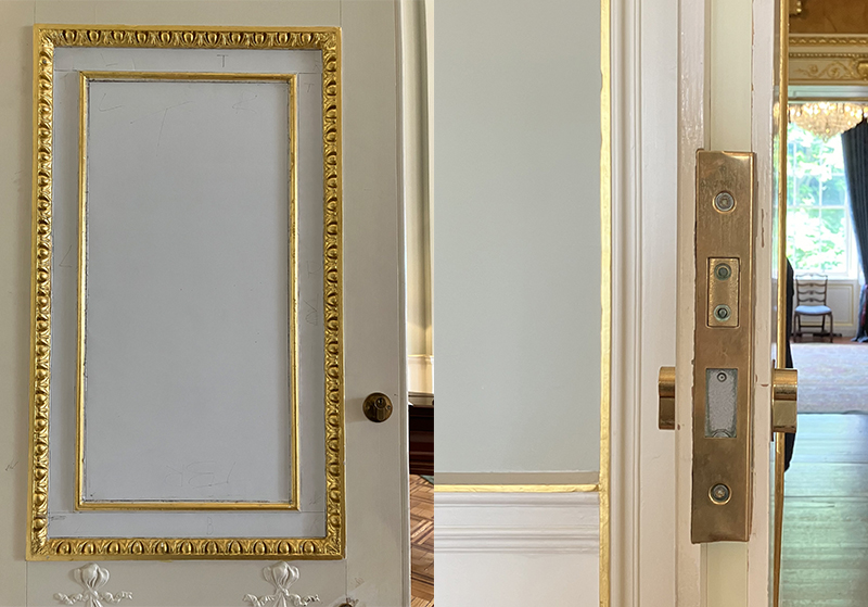 A very ornate white door with gold gilding. The door has a wooden door knob and long brass lock.