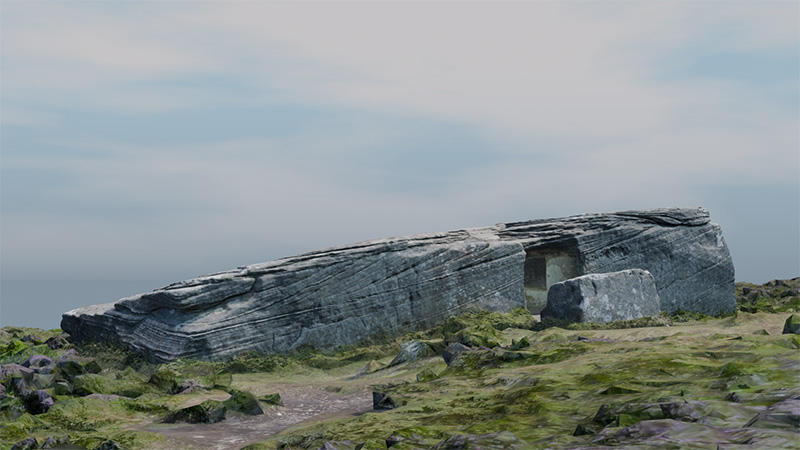 A large stone tomb, with a large entrance cut out into the stone. The tomb is surrounded by grass.