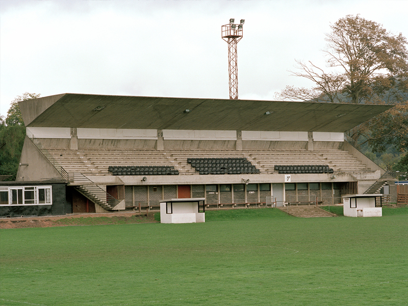 A concrete sports stadium stand by a playing field